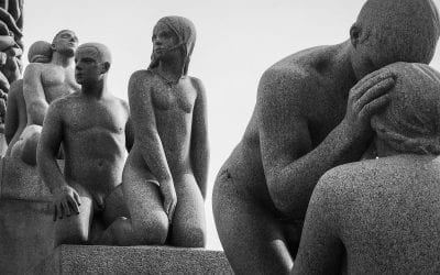 Photograph of sculptures of people in poses of mourning and companionship.